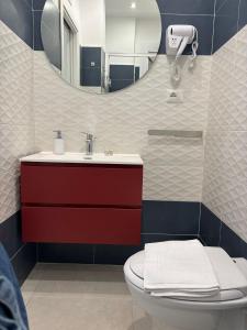 a bathroom with a sink and a toilet and a mirror at Javelin's Accomodation in Tropea +39 photos