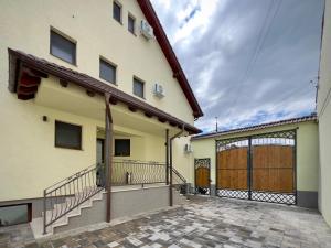 a large building with a large gate and a garage at Infinity in Sibiu