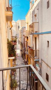 a view of an alley with balconies and plants at Casa Vacanza Venere in Barletta