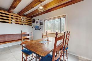 a dining room with a wooden table and chairs at Bigfoot Lodge in Angel Fire