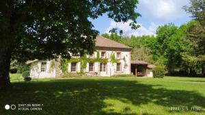 una casa blanca con un gran patio con un árbol en Maison de maître, en Sabres
