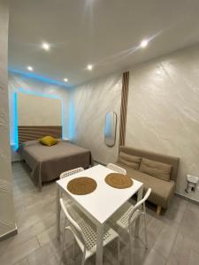 a room with a bed and a table and chairs at Casa Vacanza Venere in Barletta
