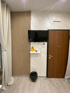 a room with a door with a television on the wall at Casa Vacanza Venere in Barletta