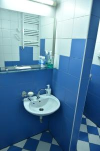 a blue bathroom with a sink and a mirror at Peron in Nikšić