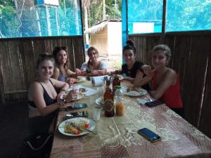 a group of people sitting at a table eating food at Ayahuasca y Turismo in Tamshiyacu