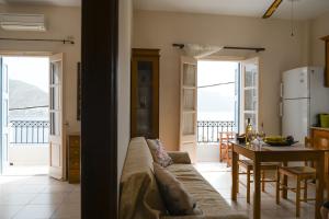 a living room with a couch and a table at Kalymnos Skalia Mountain-Sea in Skaliá