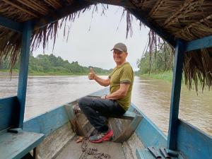 a man sitting in a boat on the water at Ayahuasca y Turismo in Tamshiyacu +133 photos
