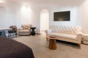 a living room with a couch and a chair at Villa Libertad in Imerovigli