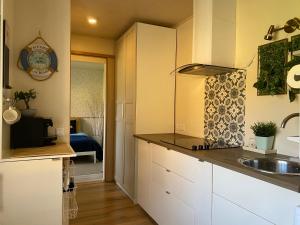 a kitchen with white cabinets and a sink at Lydia Home in Tehumardi