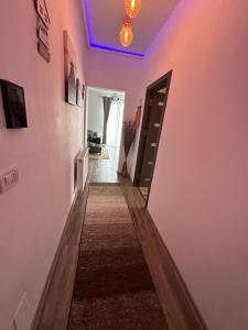 a hallway with pink walls and a purple ceiling at PartyVibe Mamaia in Mamaia Nord