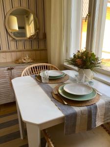 a dining room table with a white table and a mirror at Lydia Home in Tehumardi +26 photos