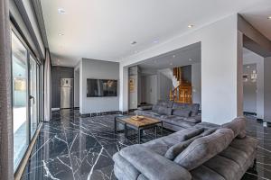 a living room with a couch and a table at NEAR BY THE LAND OF LEGENDs , 40 M2 PRİVATE POOL VİLLA BATİATUS in Belek