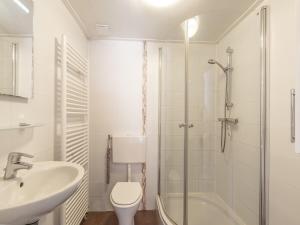 a bathroom with a sink and a toilet and a shower at Bungalow in Callantsoog near Sandy Beach in Callantsoog