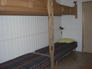 a wooden bunk bed in a small room at IMI Stølen in Oppdal