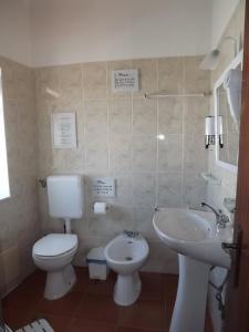 a bathroom with a toilet and a sink at Sea Studio Apartment in Budens