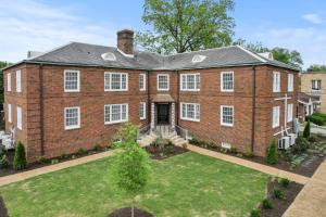 a large red brick house with a yard at The Monarch Unit 8 in Huntsville