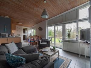 a living room with a couch and a table at Holiday Home Sint Maartenszee near Beach in Sint Maartenszee