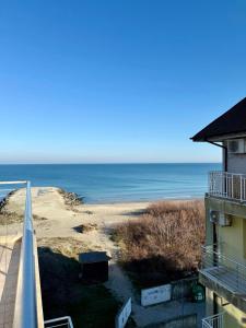 a view of the ocean from the balcony of a building at Апартамент Vista Al Mar in Pomorie
