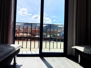a room with a view of a city from a window at SAM Apartment Cusco in Cusco