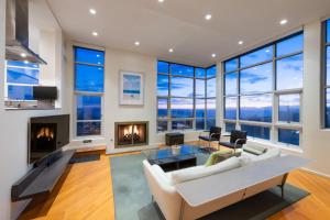 a living room with a white couch and a fireplace at Stunning Panoramic Ocean Views Penthouse Hot Tub in Manhattan Beach
