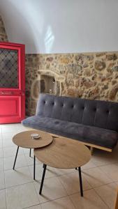 a living room with a black couch and a table at Lithino in Líthion