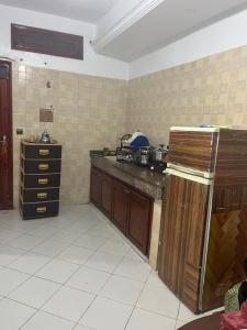 a kitchen with a counter and a refrigerator in it at Rihane housse in Essaouira