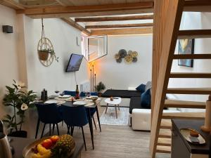 a living room with a table and a couch at BEYOND Staying Apartments Passau in Passau