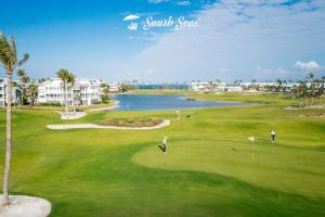 a group of people playing golf on a golf course at South Seas Resort - Official Site in Captiva