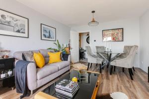 a living room with a couch and a table at Seafront townhouse in Sandgate in Sandgate