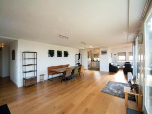 a large living room with a table and chairs at Penthouse Duinerei by the sea with sauna in Callantsoog