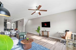 an open living room with a ceiling fan at Upscale King 3BR Townhouse in Pineville in Charlotte