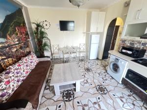 a living room with a couch and a table at Apartment in Yerevan Rubinyanc 27 21 Zeytun in Yerevan