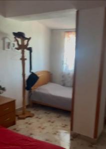 a room with a bedroom with a bed and a lamp at The Terrace in Pogradec