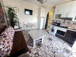 a living room with a table and a kitchen at Apartment in Yerevan Rubinyanc 27 21 Zeytun in Yerevan