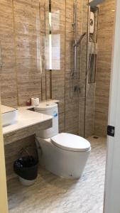 a bathroom with a toilet and a shower and a sink at Auqa Pool Villa by DRH in Ban Bung +14 photos