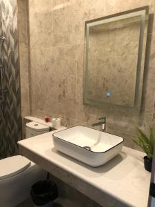 a bathroom with a sink and a toilet at Auqa Pool Villa by DRH in Ban Bung