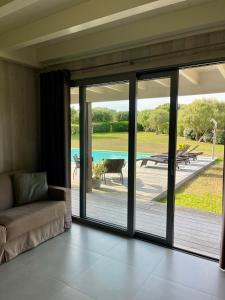a living room with sliding glass doors leading to a patio at Apartments PETIT DOMAIN DE SPERONE in Bonifacio