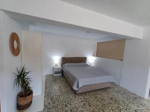 a bedroom with a bed and two lights on at The Forest Villa in Zacharo