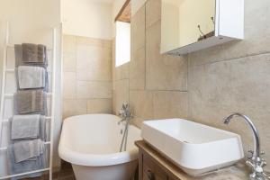 a bathroom with a sink and a toilet and a mirror at Sweet cottage 1 hr 40 min from Paris in Béthonvilliers +17 photos