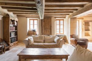 a living room with a couch and a coffee table at Sweet cottage 1 hr 40 min from Paris in Béthonvilliers