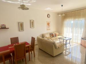 a living room with a couch and a table at Mediterranean Apartments 2 in Paphos