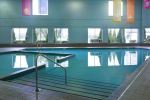 a large swimming pool in a building at Delta Hotels by Marriott Toronto Airport & Conference Centre in Toronto