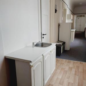a white kitchen with a sink and a refrigerator at Just 3 min Walk Old Town Center private room A in Prague