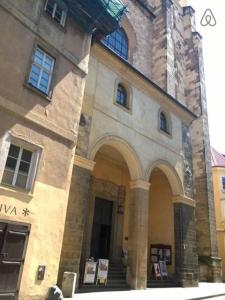 a large stone building with stairs and a tower at Just 3 min Walk Old Town Center private room A in Prague