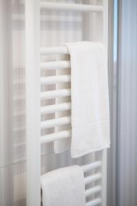 a white towel rack with white towels on it at Santo Spirito Palace in Florence