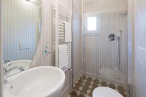 a white bathroom with a sink and a shower at Santo Spirito Palace in Florence
