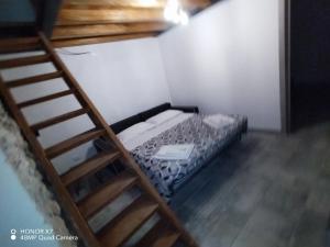 a small room with a bunk bed and a ladder at Il Loft nel Borgo in Ameglia
