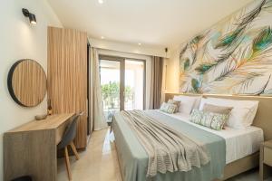 a bedroom with a bed and a desk and a painting at Maera Apartments in Sami