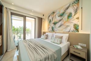 a bedroom with a bed with a painting on the wall at Maera Apartments in Sami