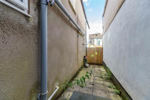 an alley with a pipe on the side of a building at 7-Min Walk to Principality and City Centre in Cardiff